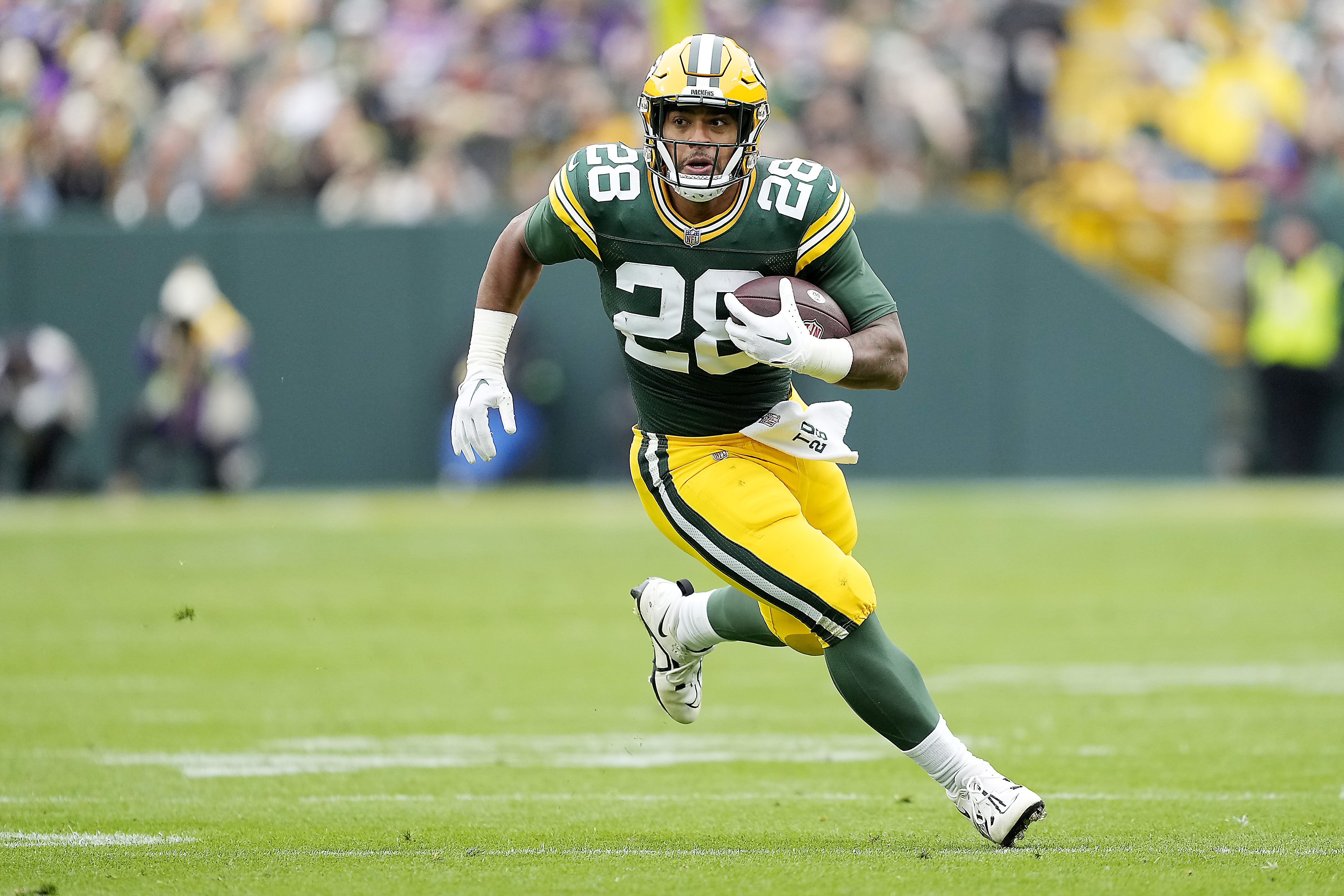 GREEN BAY, WISCONSIN – OCTOBER 29: AJ Dillon #28 of the Green Bay Packers runs with the ball after a fourth quarter catch against the Minnesota Vikings at Lambeau Field on October 29, 2023 in Green Bay, Wisconsin. (Photo by Patrick McDermott/Getty Images)